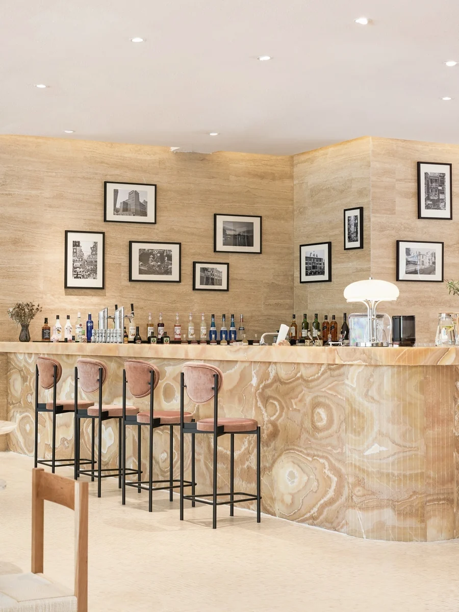 Warm-toned stone wrapping the front of a softly curved bar