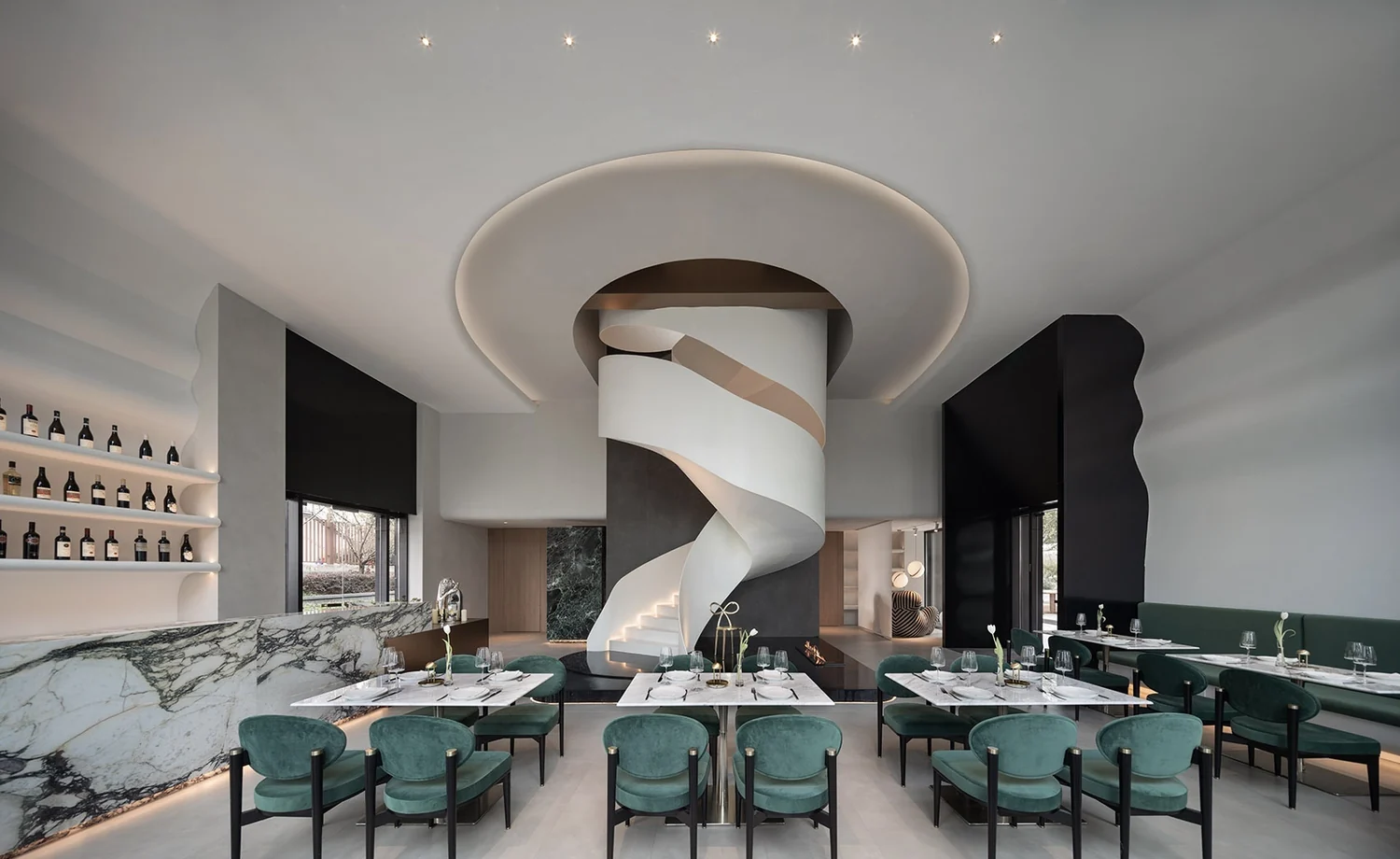 Hospitality interior with a sculptural stair and natural stone surfaces