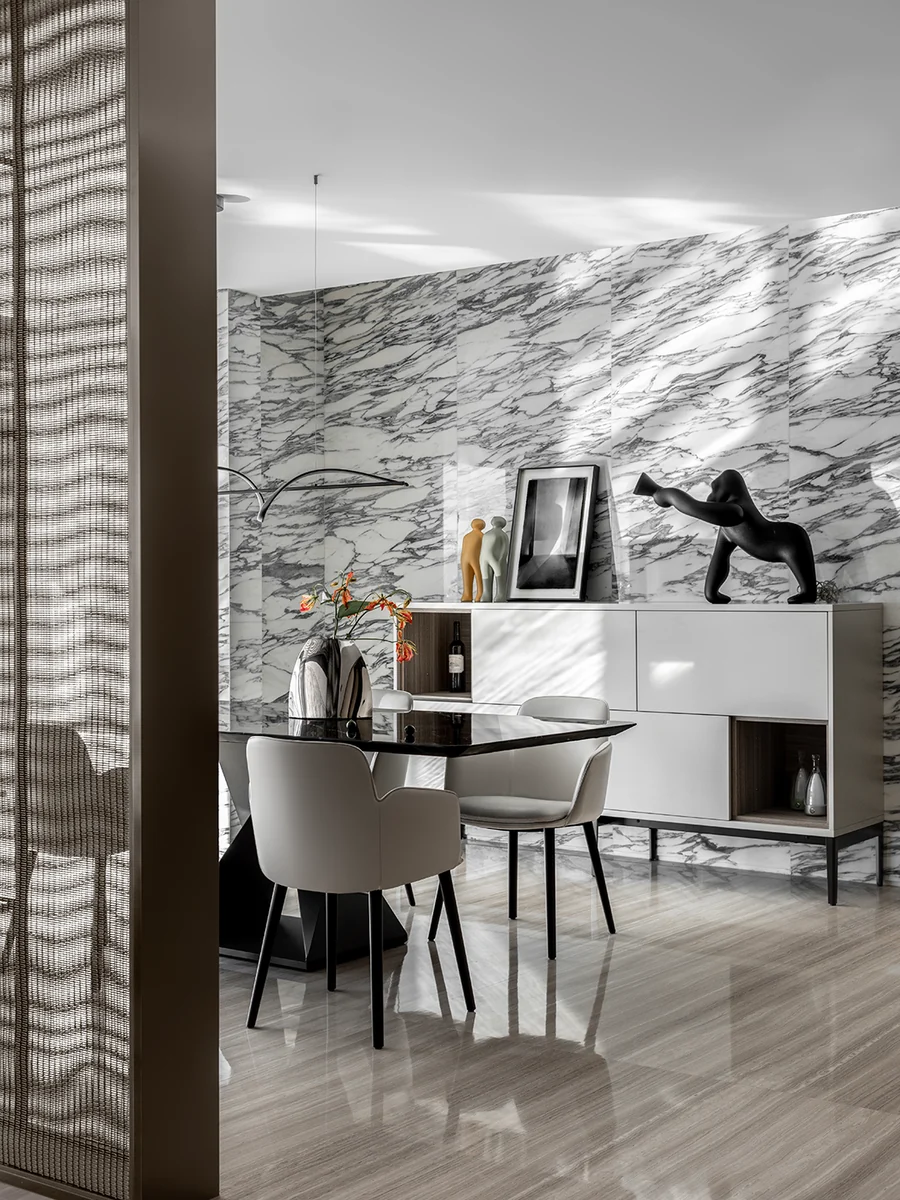 Natural stone wall panels and fitted furniture viewed in changing daylight